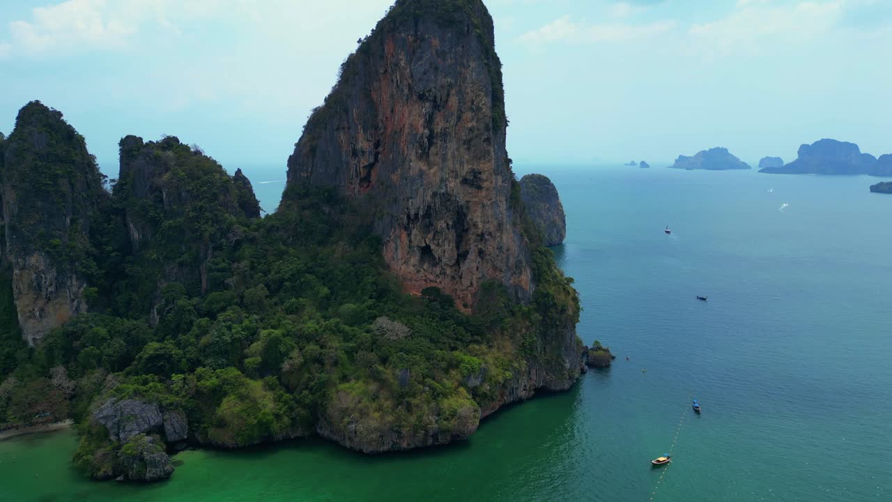 Rock climber resting during a difficult climb on Rai Leh beach cliff in Thailand. Nice aerial view flight speed ramp hyper motion time lapse