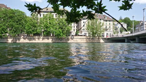 passing passenger ship on river limmat at city of zürich on a sunny spring day.