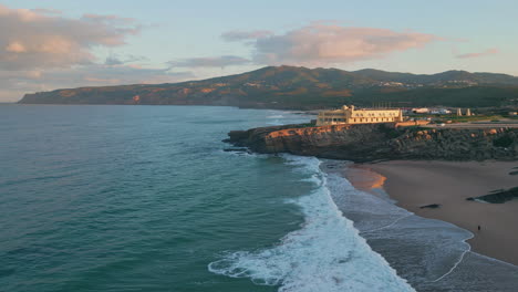 aerial serene coastal evening with town landscape. golden sunset light on cliffs