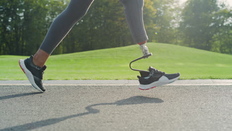 Jogger-with-artificial-limb-doing-cardio-on-road.-Athlete-running-outdoors