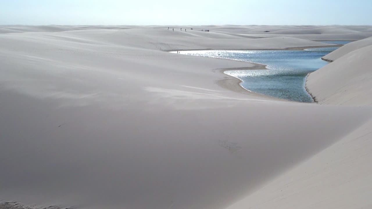 North brazil Lençóis Maranhenses kitesurfer lagoon, dunes paradise, desert water sports, aerial view panorama drone 4k.