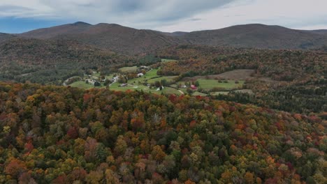 countryside landscape with mountains and autumn forests - aerial drone shot