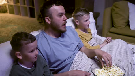 father and sons watching movie