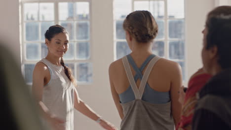 yoga class group of women women chatting having conversation sharing lifestyle ready for workout in fitness studio