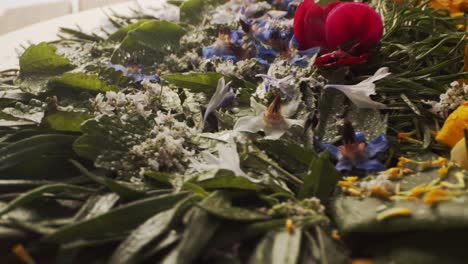 Plate-of-edible-leaves-and-flowers-rotating-on-the-table