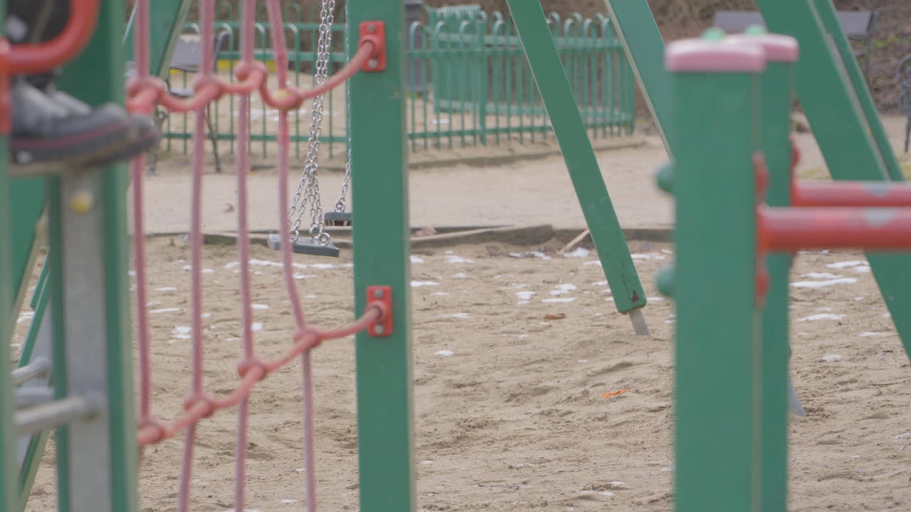 Swinging swing in the playground. Empty play area
