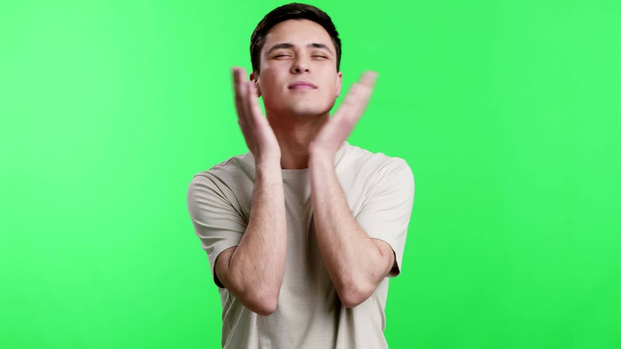 Young man slapping his cheeks, chroma key background
