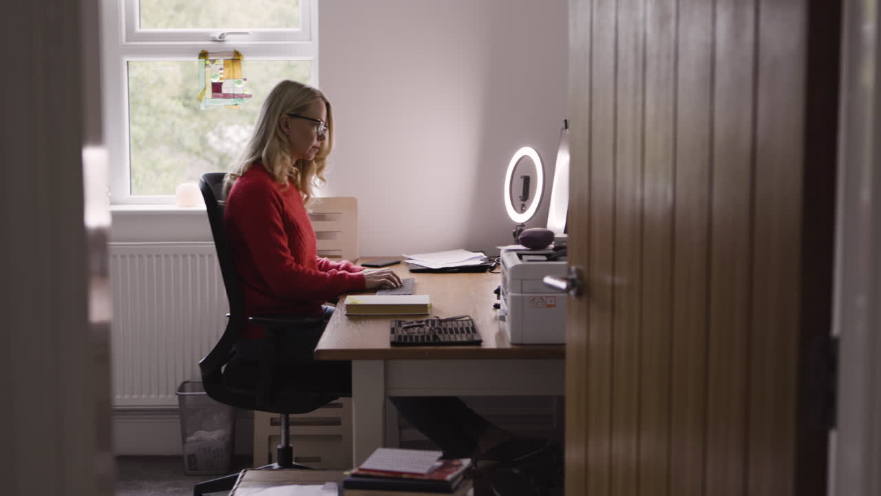 Woman working at a desk in her home office