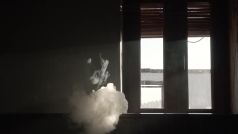 smoke from a vaper in a dark room in slow motion