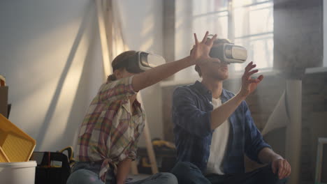 young family sitting in headsets among construction tools in light room.