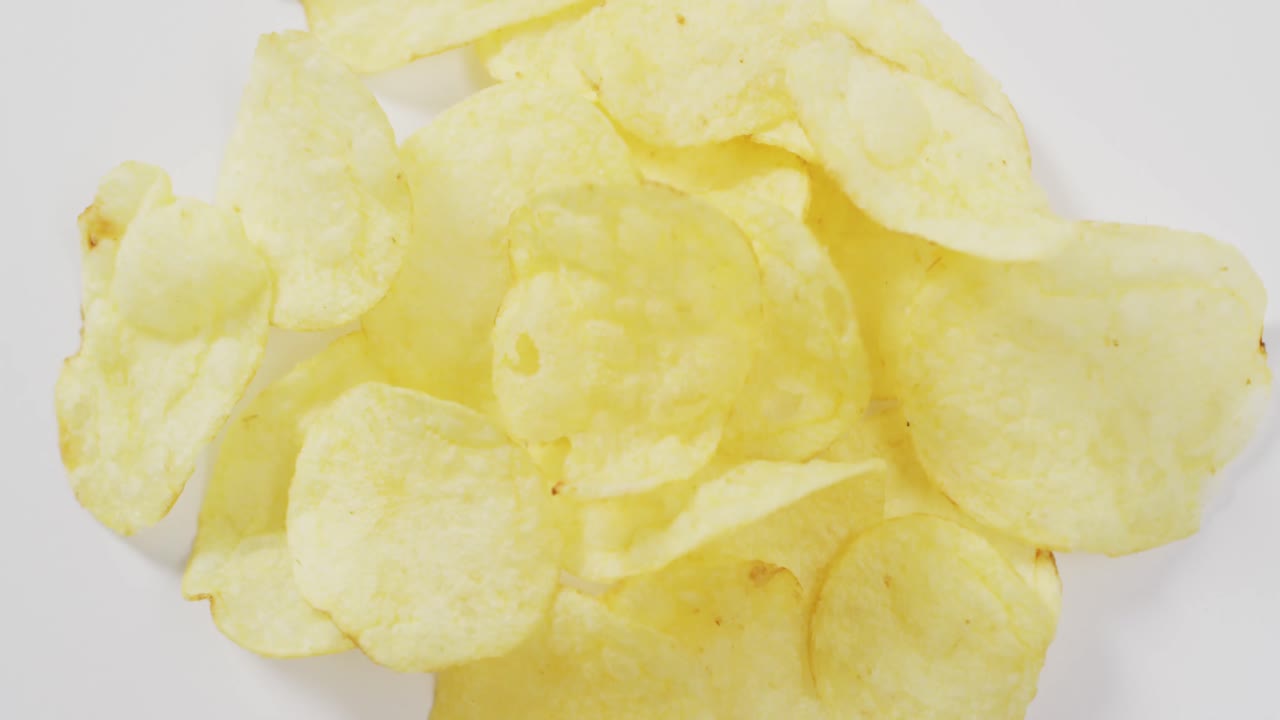 Close up of potato chips with copy space on white surface