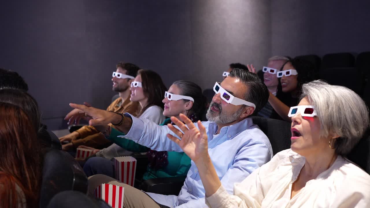 People Enjoying a 3D Movie in a Theater