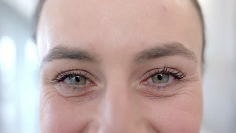 portrait of happy eyes of caucasian female doctor in hospital room, slow motion