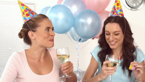 women clinking their flutes of champagne celebrating a birthday