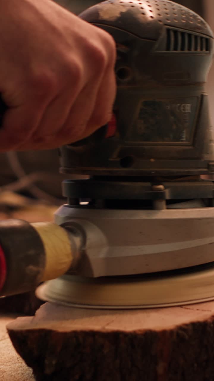 Close-up of a Woodworker Sanding a Live Edge Wood Slab