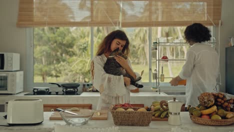 couple preparing breakfast with cat in a beautiful kitchen