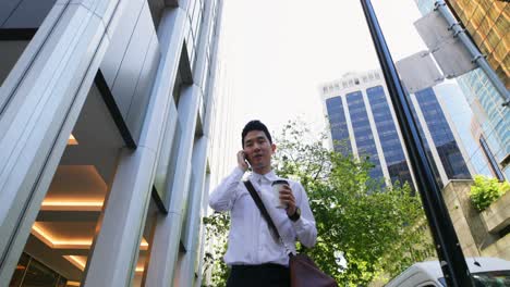 man talking on mobile phone while walking on street 4k