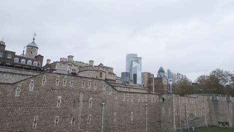 iconic skyscrapers behind the tower of london on a cloudy day