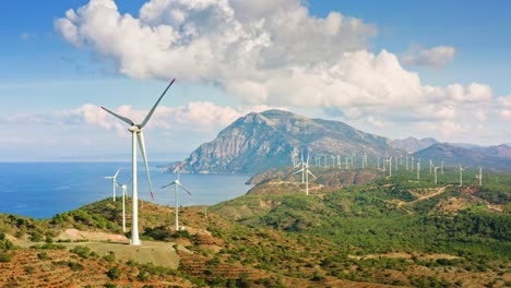Wind-power-generators-among-Turkish-landscape-with-mountains-and-Mediterranean-sea,-Reşadiye-peninsula,-Muğla