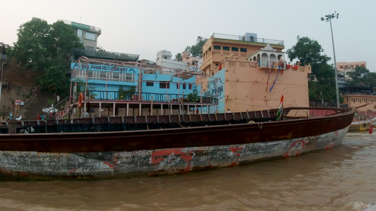 gente cinematográfica se reúne ganges río crucero chowk canal barco varanasi estado de la india del norte antigua ciudad santa khidkiya ghat provincia de pradesh paisaje gris nublado todavía tranquilo fangoso marrón pan derecho movimiento