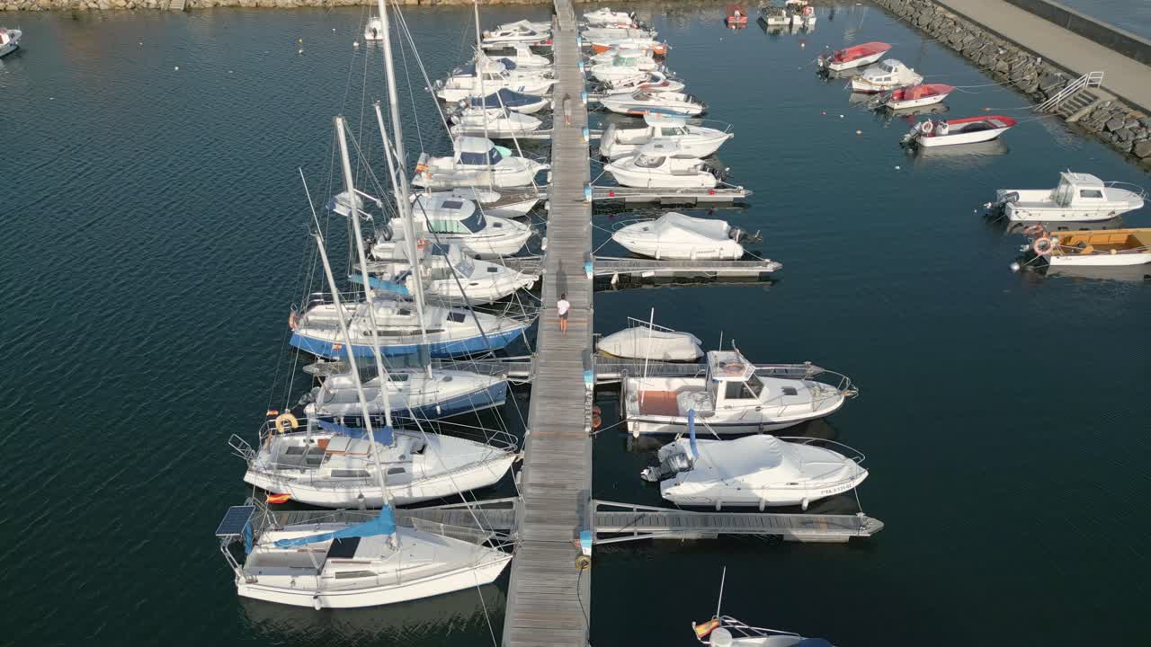 Two People Walking Towards The Port Of Yacht Club At Rianxo In A Coru&ntilde;a, Spain