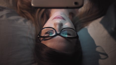 Woman Reading on Tablet in Bed