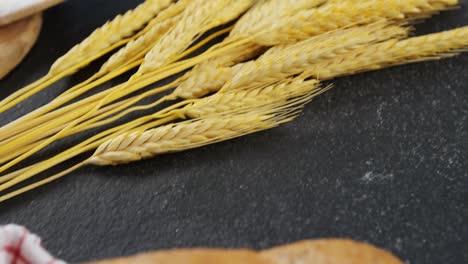 baguette wrapped in napkin and wheat grains