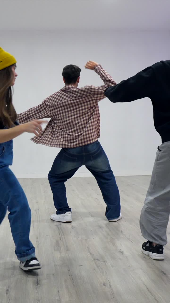 Two young adults dancing in a studio