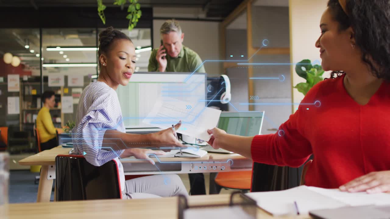 Seated woman turning toward red colleague handing papers, signing for approval amid tech overlay