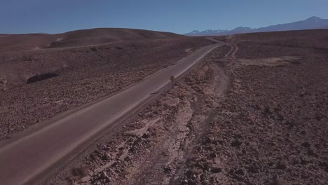 epic aerial view of a car driving through the atacama desert, chile, bolivia