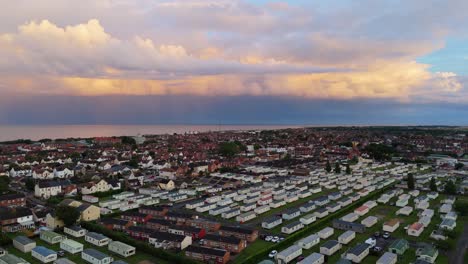 coastal panorama of the town of skegness with looming storm clouds over the north sea. seaside scene with rooftops at sunset