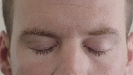 close-up-caucasian-man-eyes-opening-looking-at-camera-pensive-contemplative