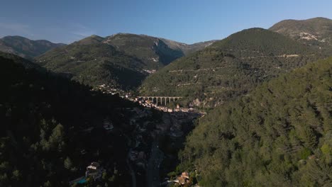 Un-Pintoresco-Pueblo-Ubicado-En-Las-Exuberantes-Montañas-Verdes-De-La-Riviera-Francesa,-Vista-Aérea