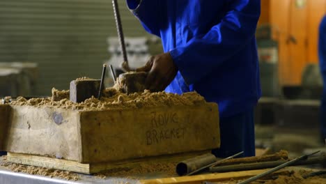 worker putting soil in wooden mold in workshop 4k