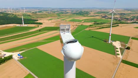 the head of the wind turbine is currently being constructed - drone flying forward