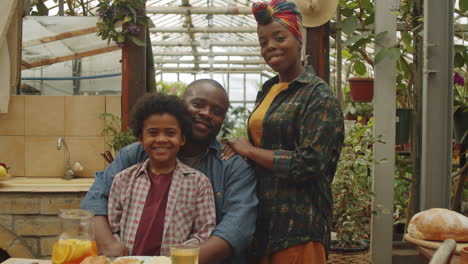 portrait of happy afro family at dinner in greenhouse farm