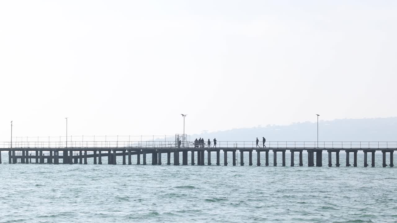 People strolling along a pier in Melbourne