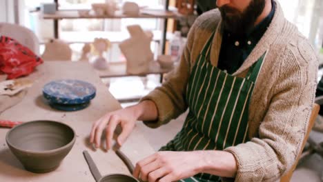 Attentive-potter-making-pot