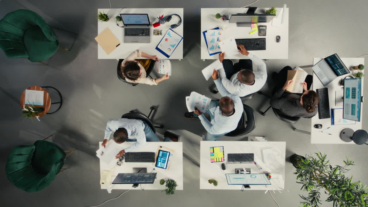 Vertical Video Top down view of diverse coworkers analyzing business data and metrics