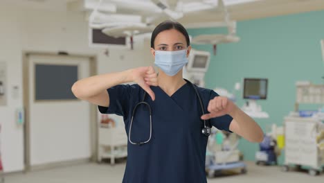 Unhappy-Indian-female-doctor-showing-thumbs-down