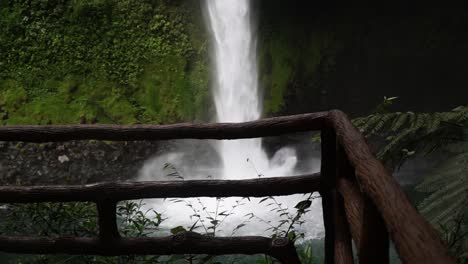 Admiring-a-beautiful-waterfall-as-it-plunges-down-the-lush-green-rocky-cliffs