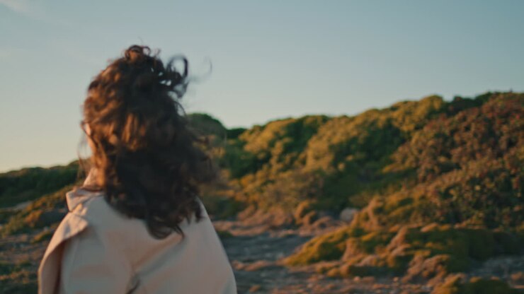 glückliche frau läuft abends hügel. fröhliche sorgloses mädchen dreht sich und genießt das leben