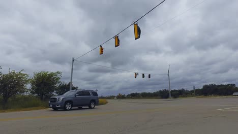 Traffic-lights-swinging-on-there-cables-as-the-wind-starts-to-pick-up-building-to-a-stormy-day