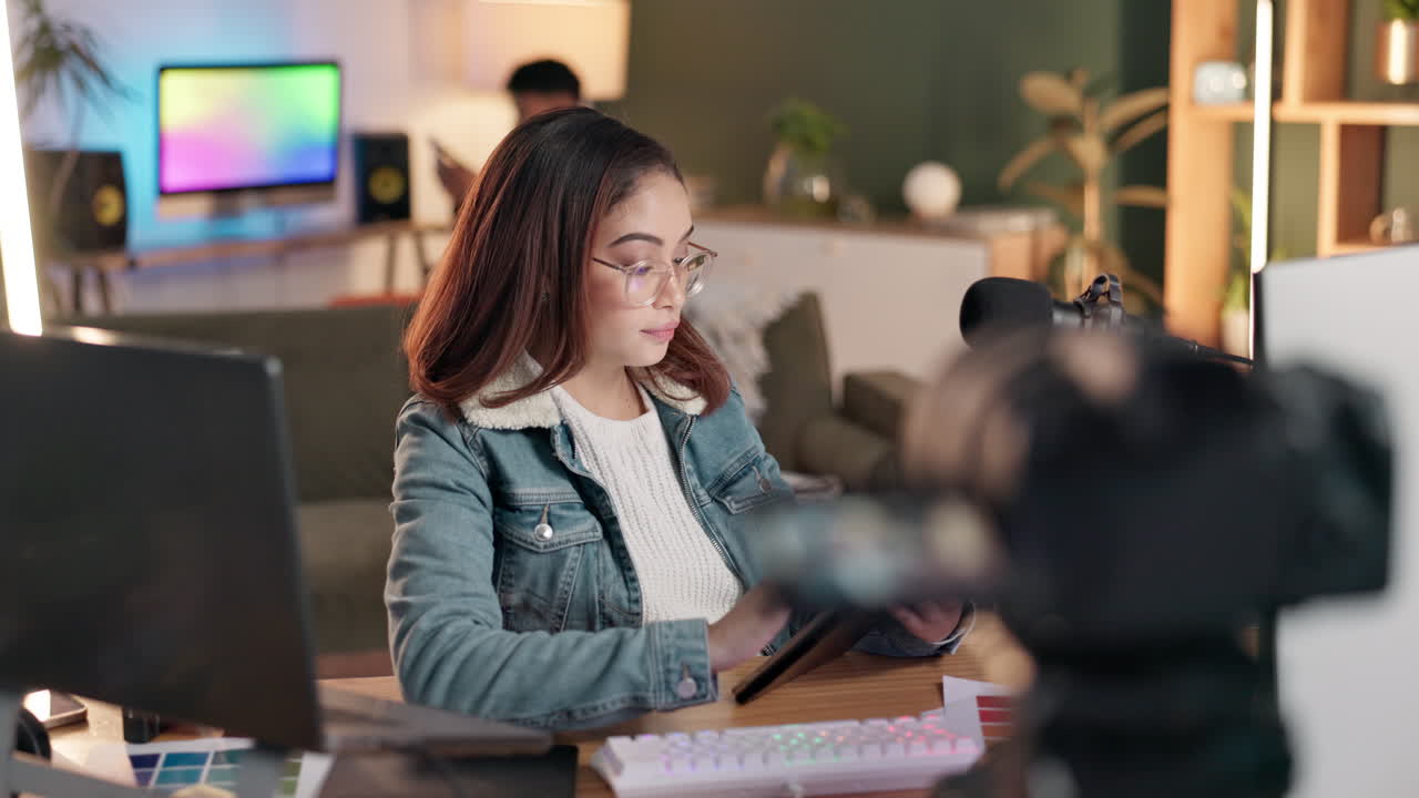 Woman working at desk with tablet and laptop