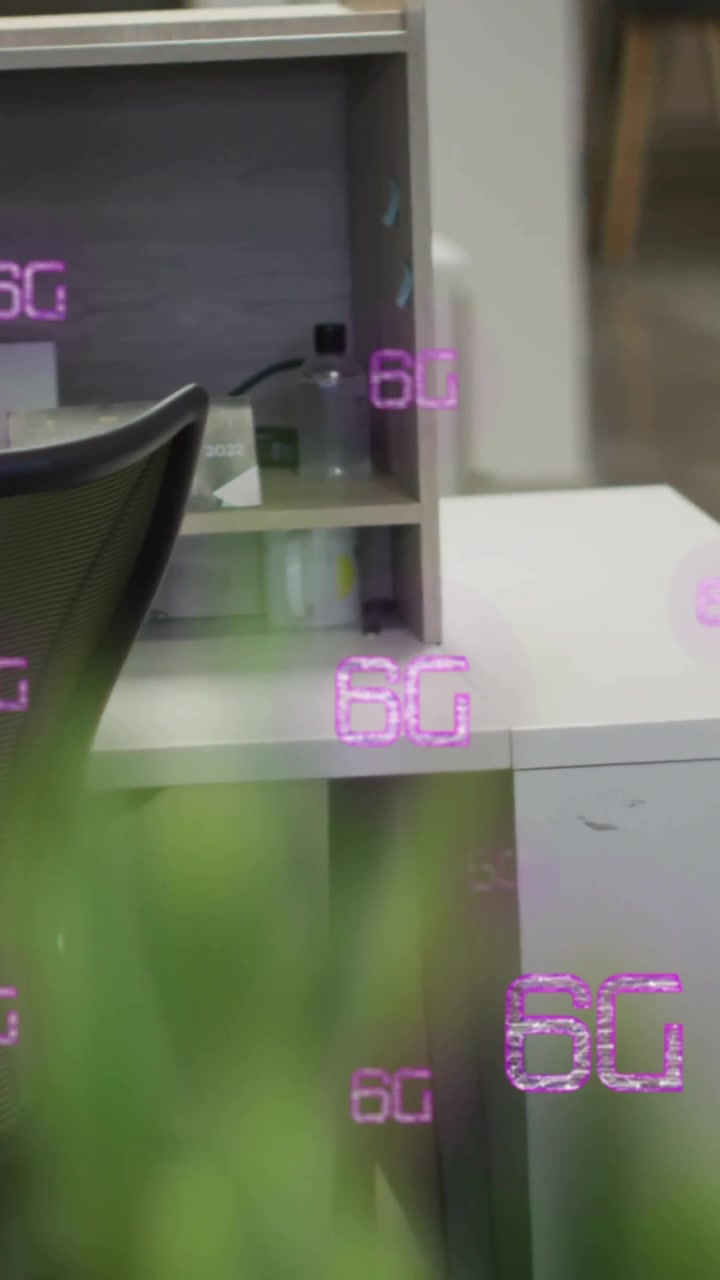 6G text animation over empty office desk with computer and chair