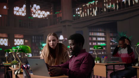 vertical video diverse students working together on a college assignment at the library