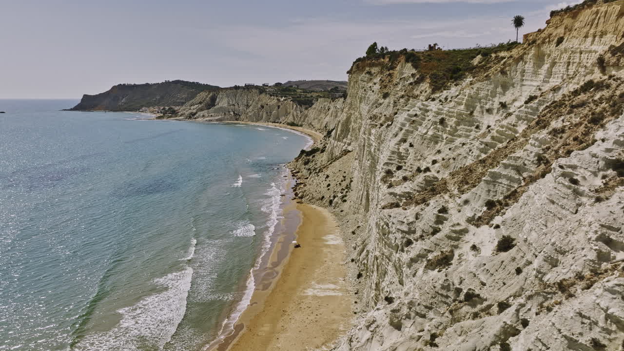 scala dei turchi italy aerial v5 drone fly alongside striking natural landmark capturing limestone sea cliffs and sandy beach with beautiful mediterranean sunshine - shot with mavic 3 cine - june 2023