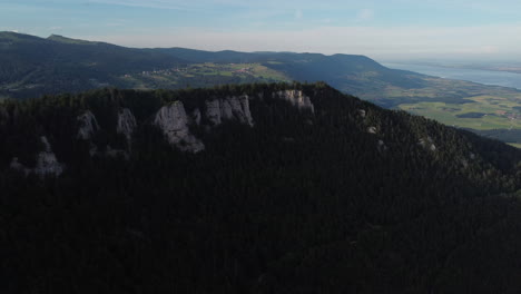 aerial rotating shot high above the mountains and countryside of sainte croix, switzerland on a sunny day