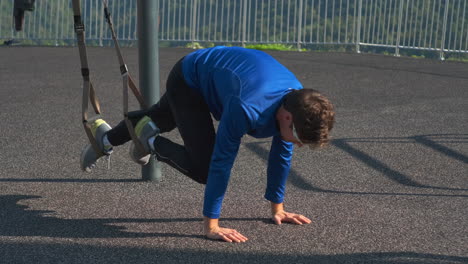 man performing suspension training outdoors