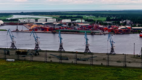 cranes in shipping cargo port - aerial drone shot